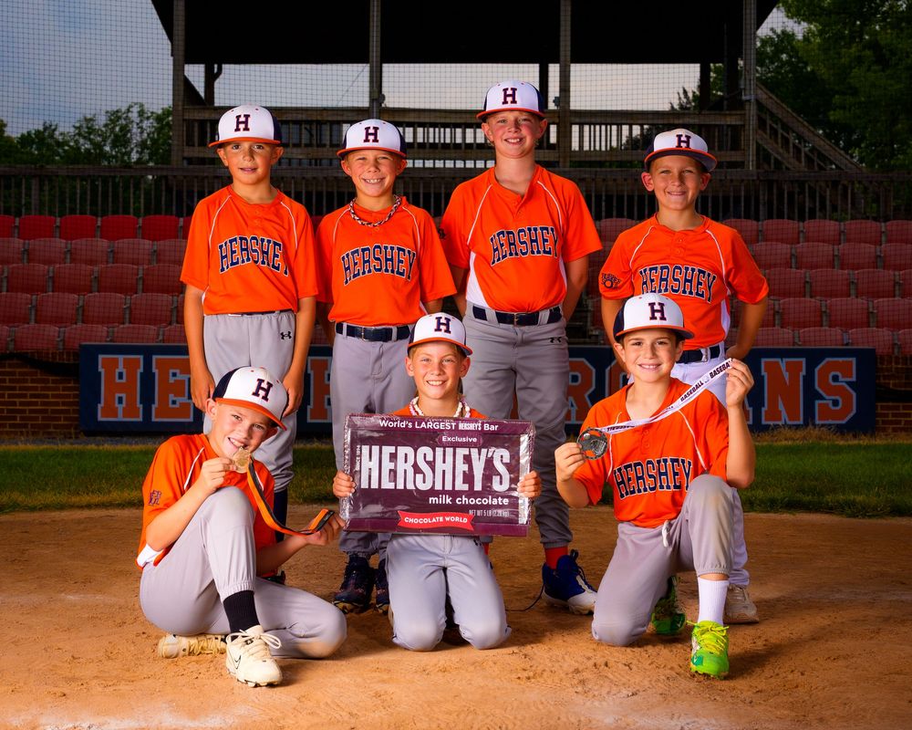 Little League All-Star baseball team posing at home plate with dramatic lighting in Hershey PA, photographed by SportsFox Photography.
