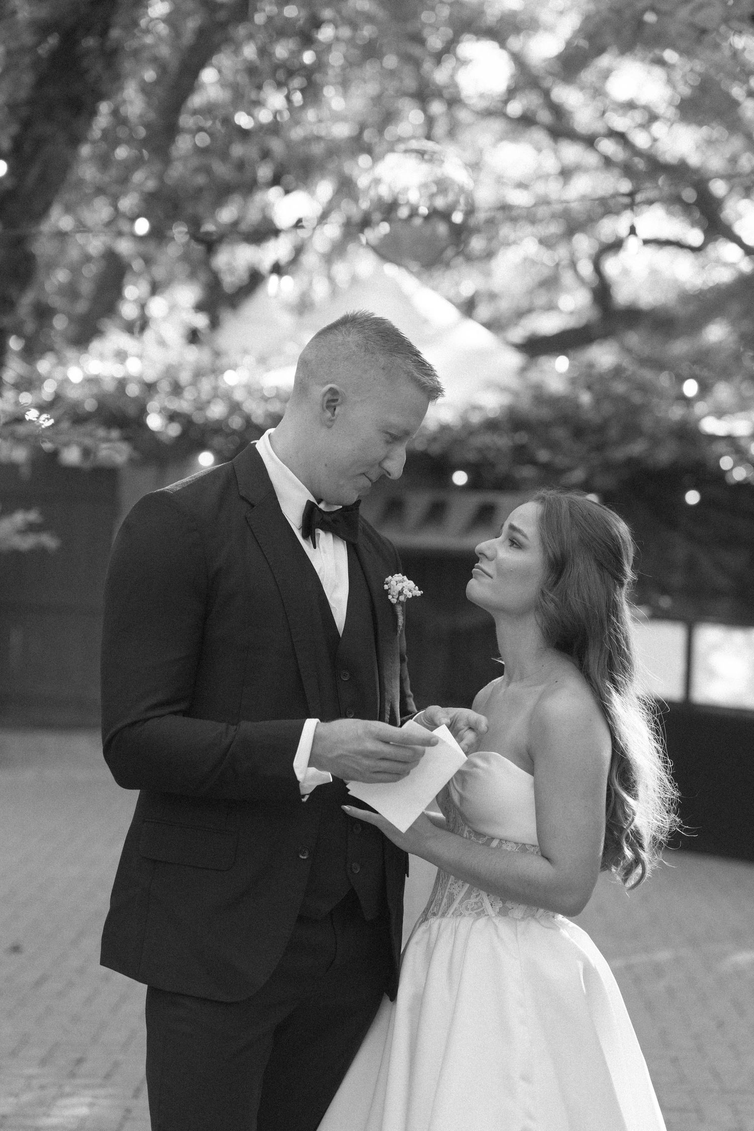 A romantic black and white wedding photo sequence shows a couple playfully interacting during their outdoor photo session.