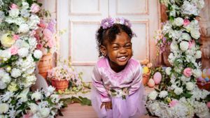 Whimsical spring portraits with pink and white floral decorations in studio setting.