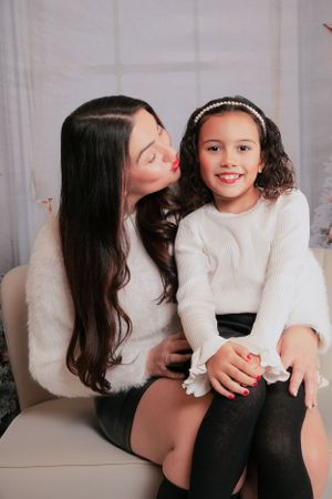 Intimate portrait session with white sweaters against neutral gray studio backdrop.