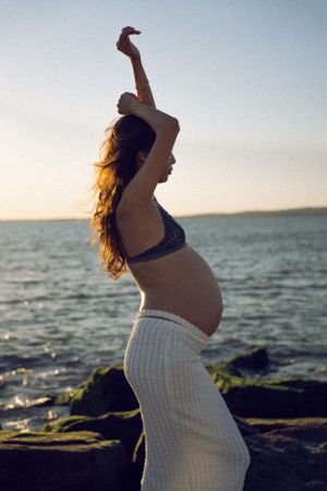 Dreamy and cinematic maternity session by the ocean, golden light, and timeless beauty, capturing the magic of motherhood maternity NYC