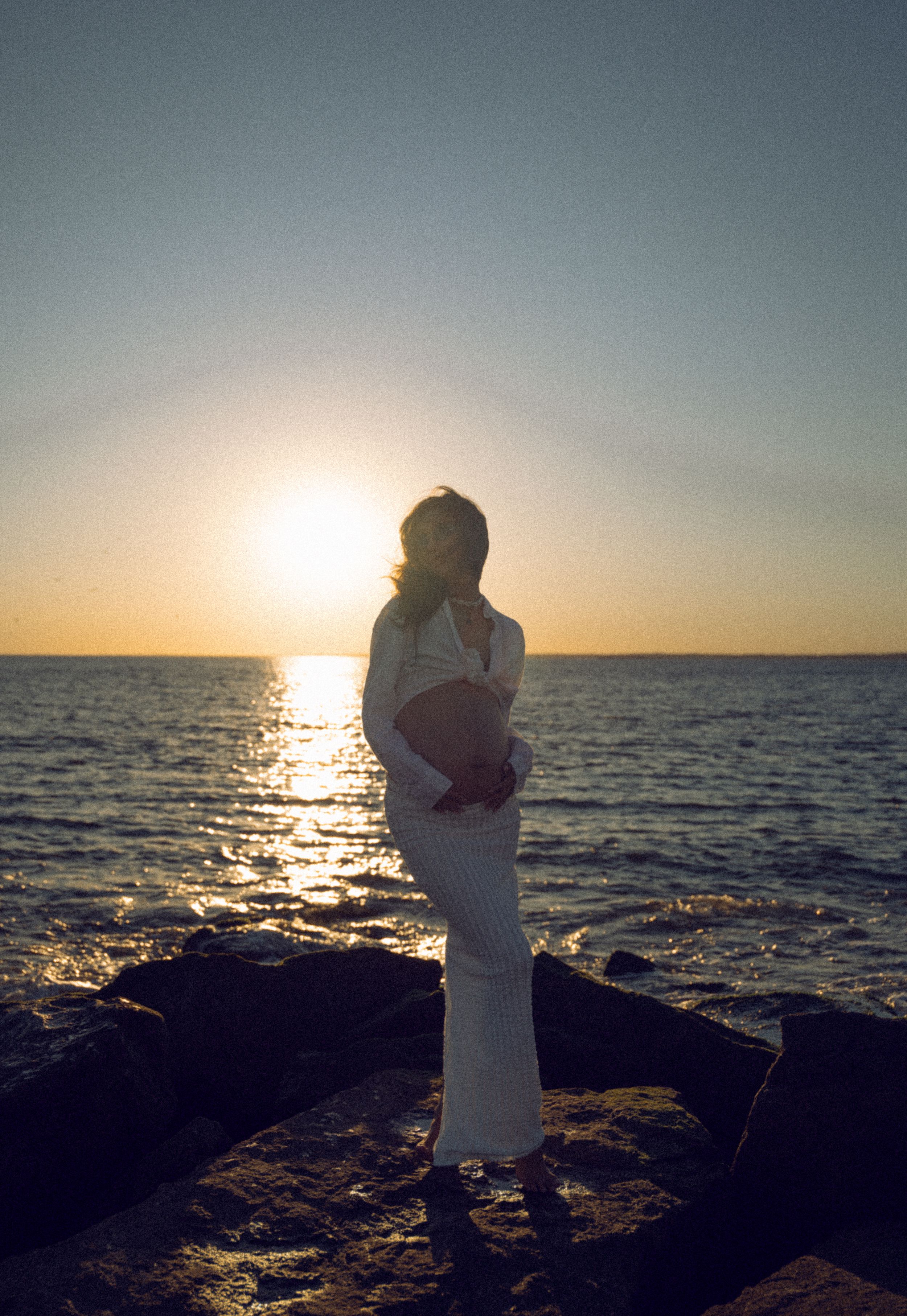 Dreamy and cinematic maternity session by the ocean, golden light, and timeless beauty, capturing the magic of motherhood maternity NYC