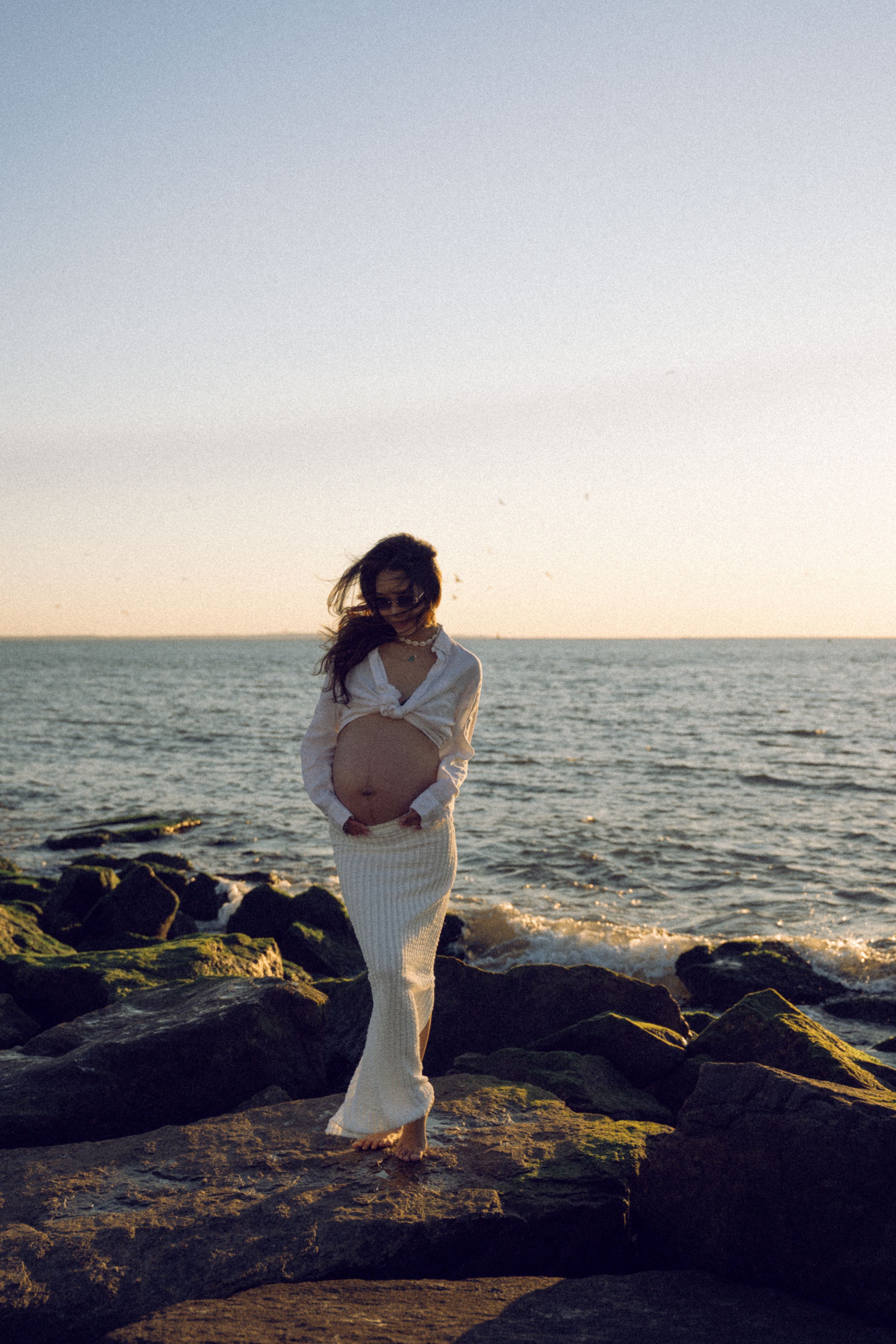 Dreamy and cinematic maternity session by the ocean, golden light, and timeless beauty, capturing the magic of motherhood maternity NYC