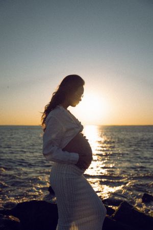 Dreamy and cinematic maternity session by the ocean, golden light, and timeless beauty, capturing the magic of motherhood maternity NYC