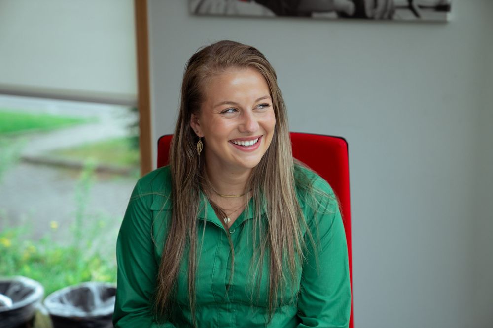 Beautiful woman smiling in a professional business portrait, dressed modestly for the workplace in Hasselt.