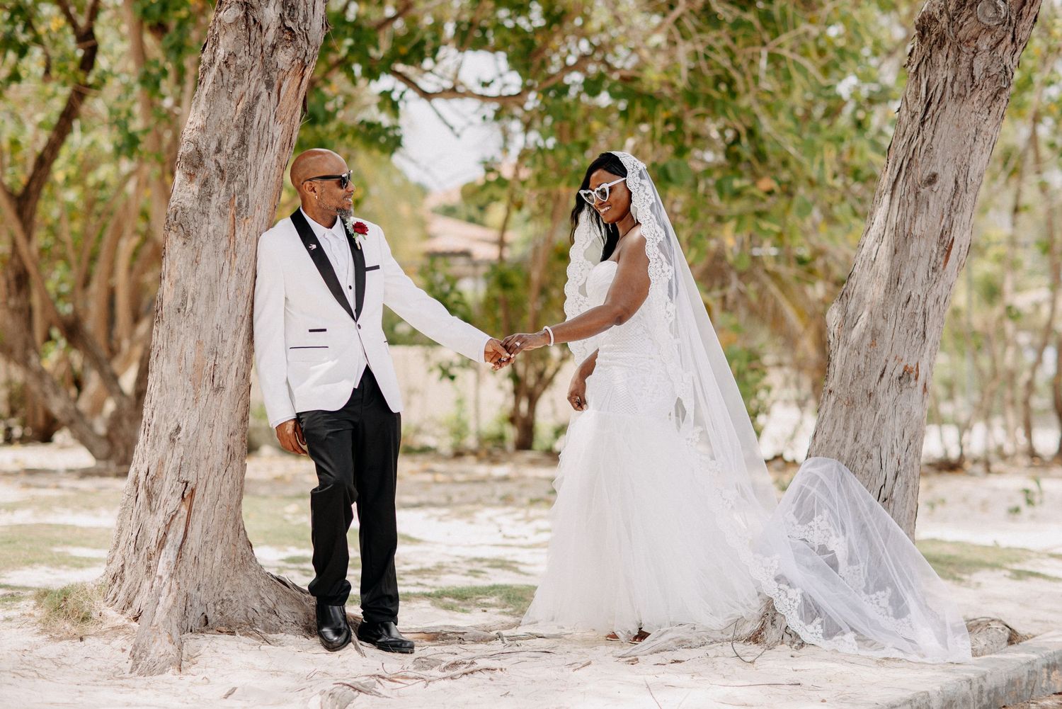 A romantic wedding photoshoot in a wooded outdoor setting with natural lighting.