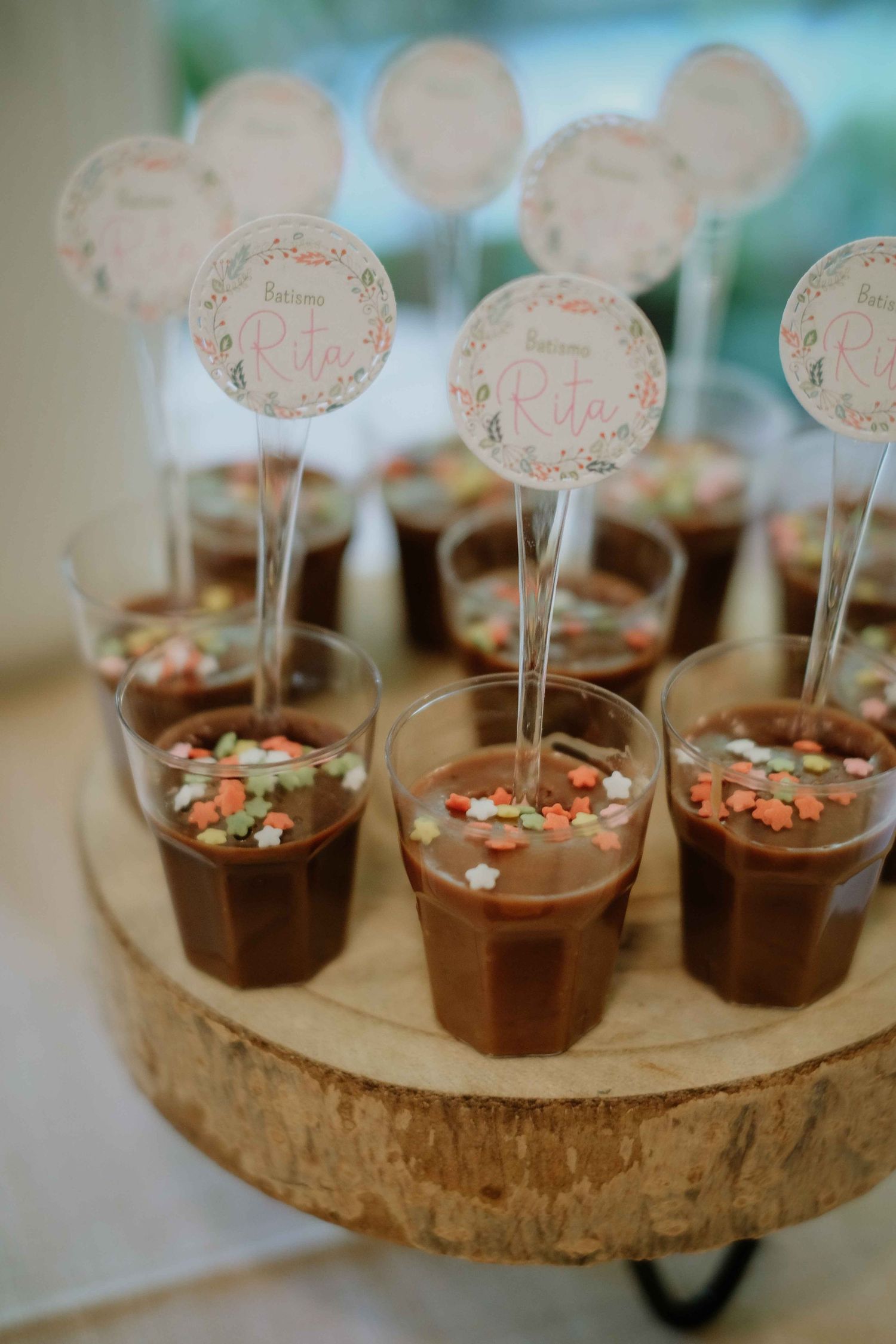 Chocolate desserts displayed on wooden slices with decorative toppers.