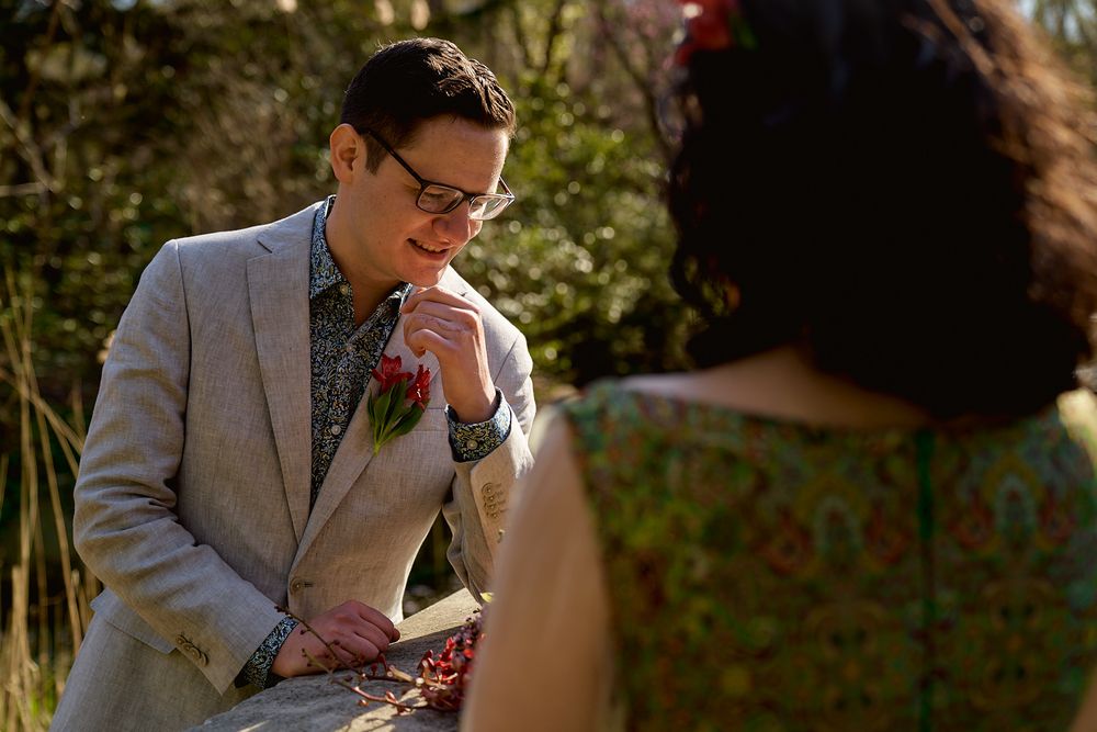 A romantic outdoor portrait in warm sunlight with garden scenery.