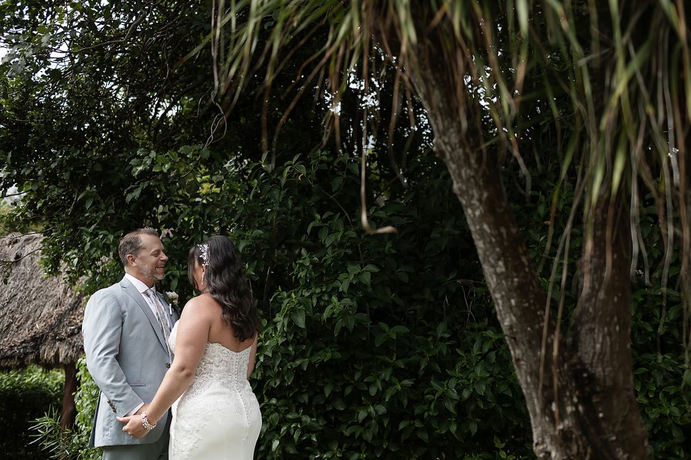 Intimate moment in jungle garden, bride and groom portraits.