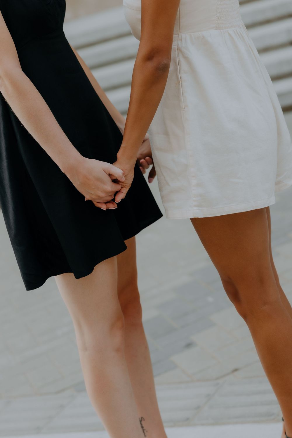 Close-up of LGBTQ+ couple holding hands — soft romantic tones by inclusive wedding photographer.