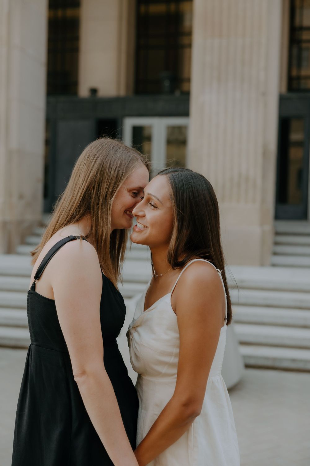 Intimate forehead-to-forehead moment between two brides captured by inclusive wedding photographer.