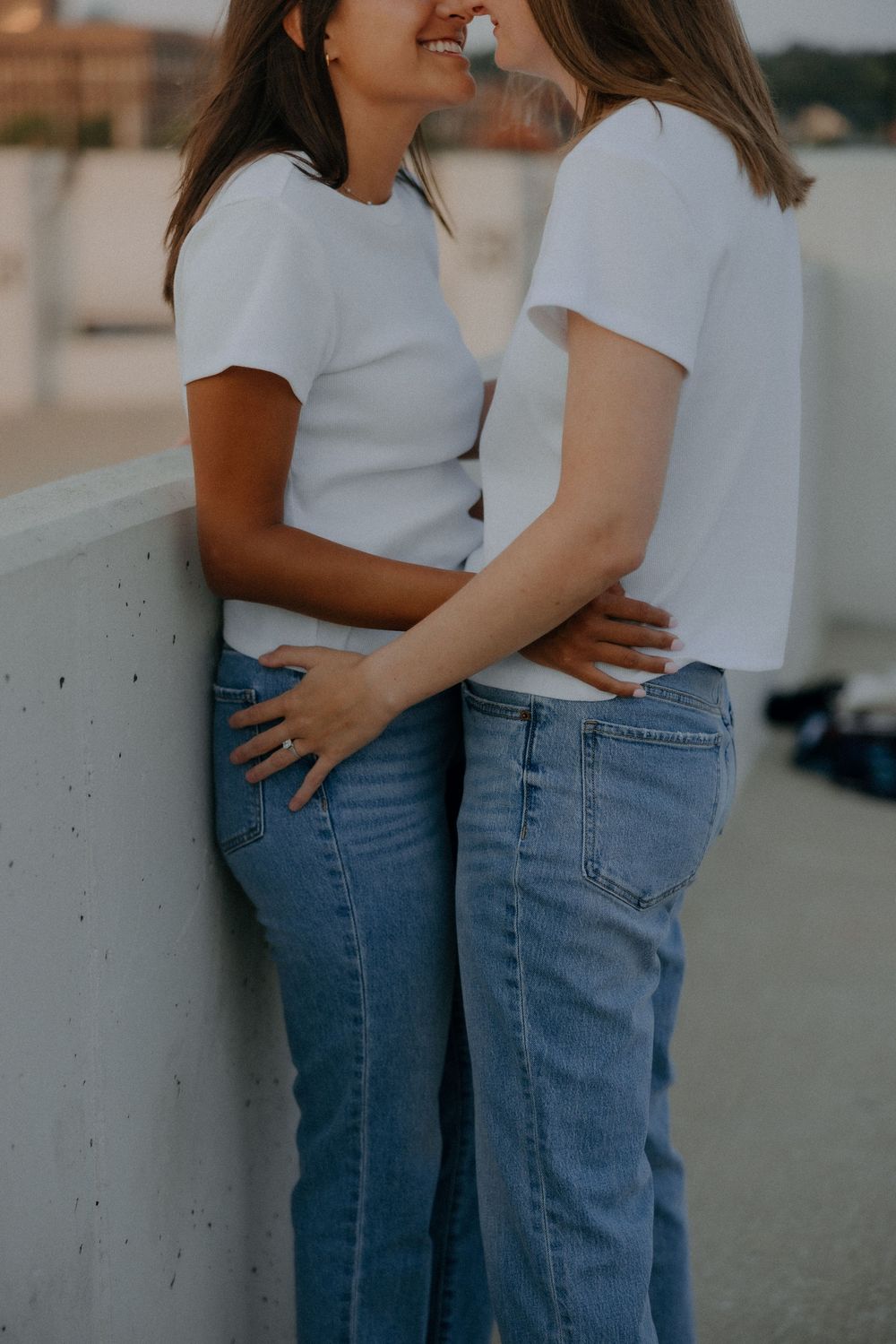 Rooftop engagement photos of LGBTQ+ couple in downtown Grand Rapids by Michigan wedding photographer.