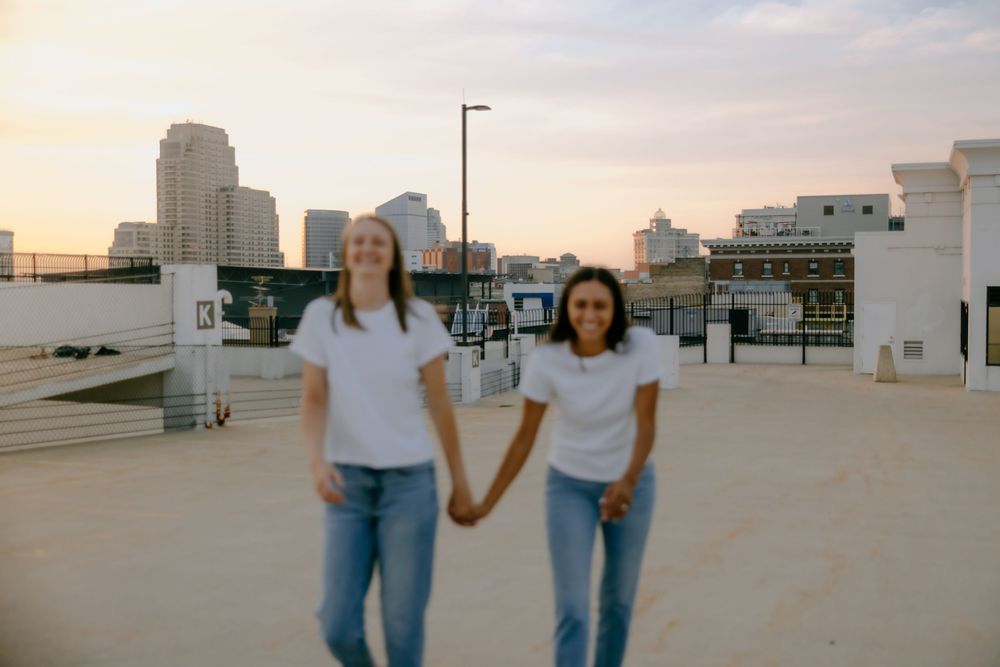 Rooftop engagement photos of LGBTQ+ couple in downtown Grand Rapids by Michigan wedding photographer.