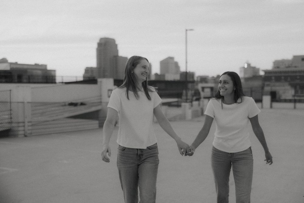 Rooftop engagement photos of LGBTQ+ couple in downtown Grand Rapids by Michigan wedding photographer.