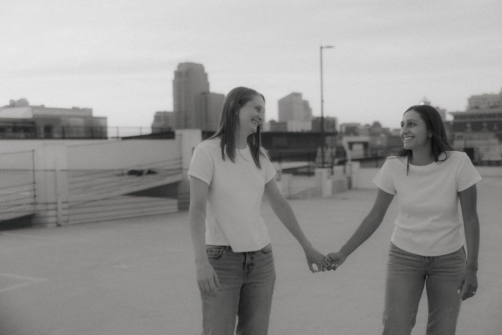 Rooftop engagement photos of LGBTQ+ couple in downtown Grand Rapids by Michigan wedding photographer.