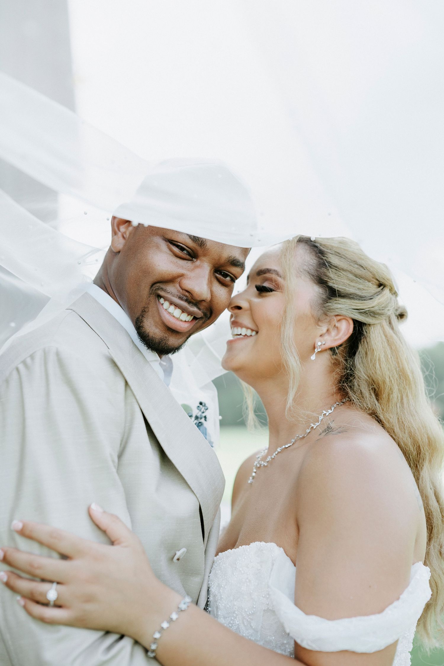 Close up wedding portrait showing joyful moment between newlyweds.