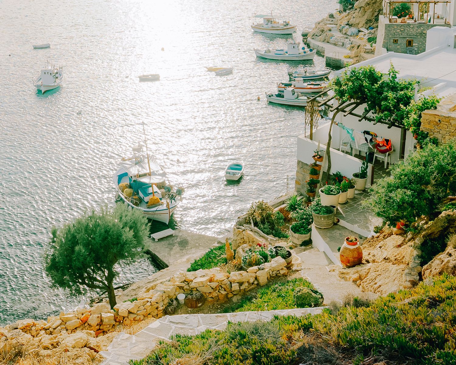 View of fishing harbor with small houses and green hillside