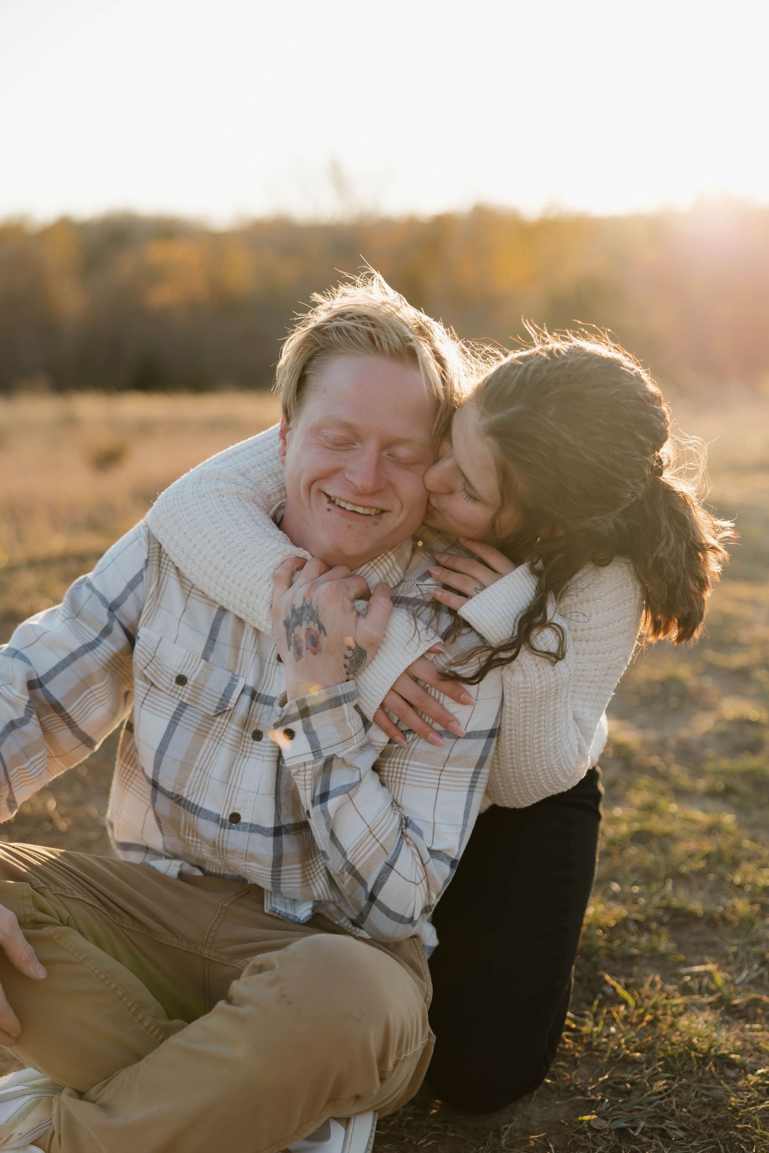 A heartwarming series of candid outdoor photos showing playful moments between two people at sunset in a field.