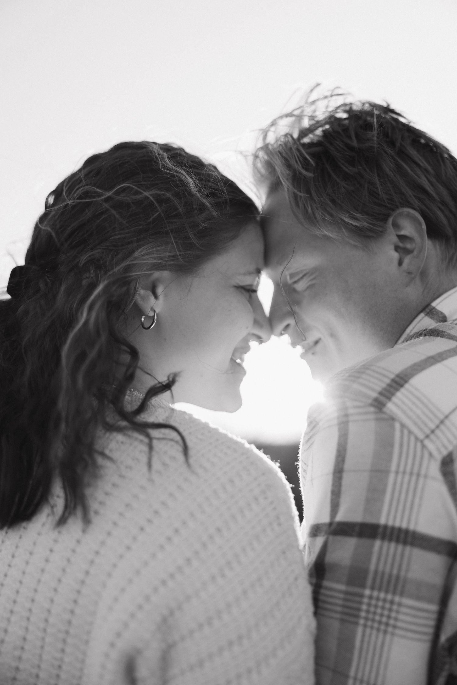 A romantic black and white photo sequence showing a couple in silhouette moving closer together for a kiss.