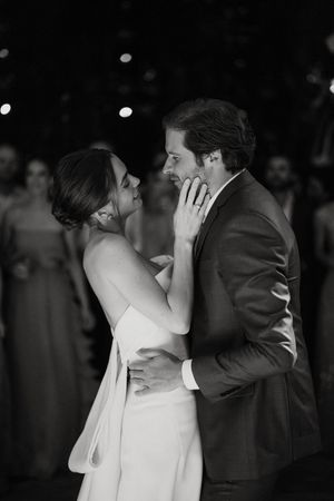 A bride and groom share an intimate moment during their first dance at their wedding reception.
