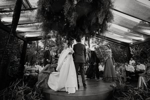 Black and white film strip showing various wedding scenes with dancing, couples, and decor in an indoor reception venue.