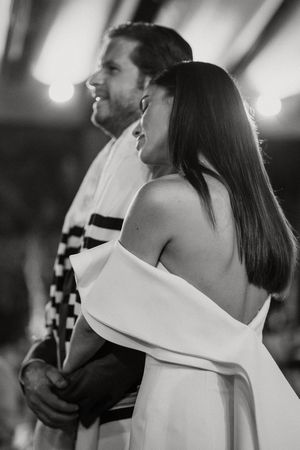 Black and white image sequence showing back view of a person in a structured white top with a dramatic collar detail.