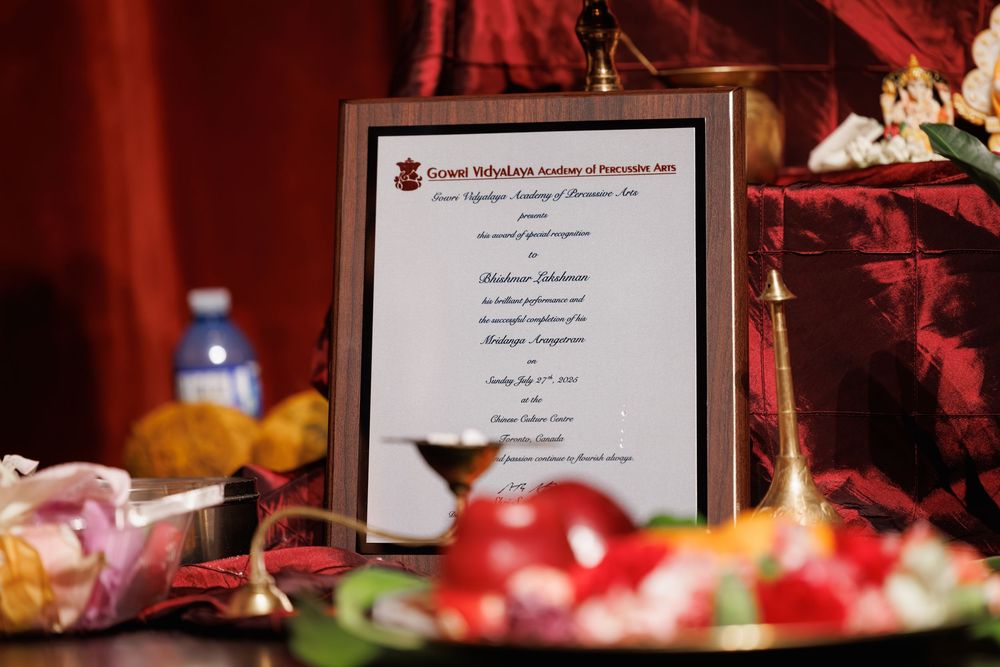 Event signage and decorative displays arranged on tables with red tablecloths.