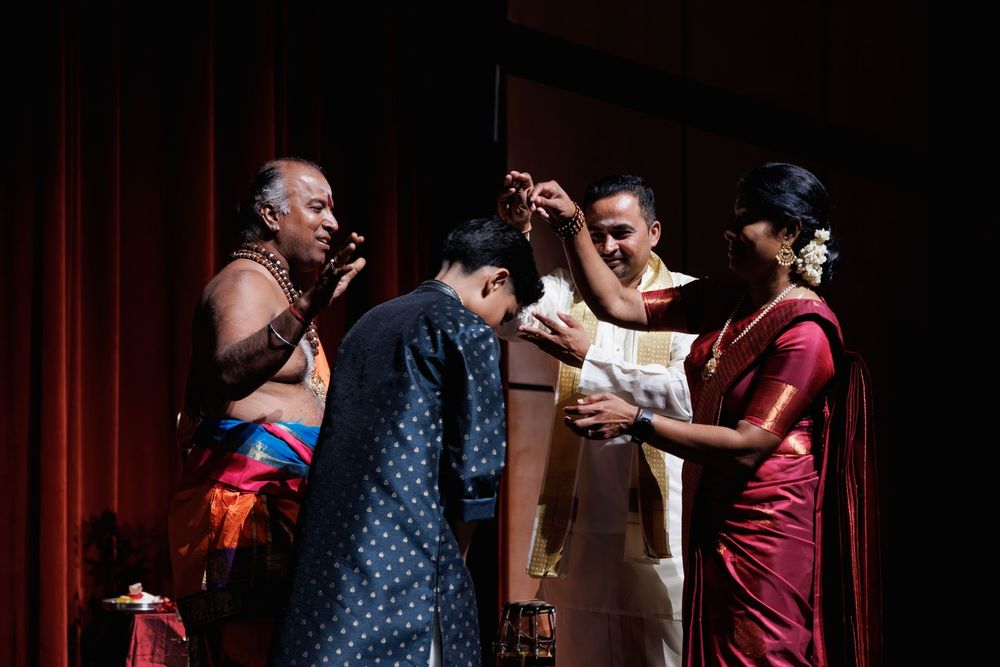 Performers interact on stage during a cultural music performance.