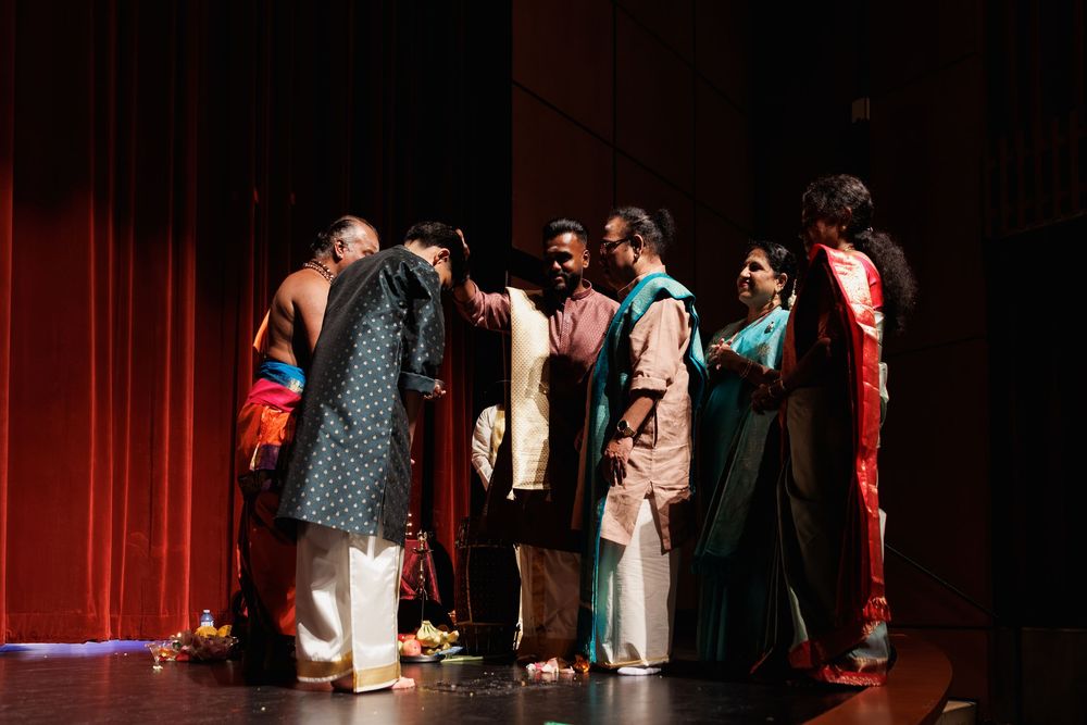 Stage performers in traditional Indian clothing during a theatrical production.
