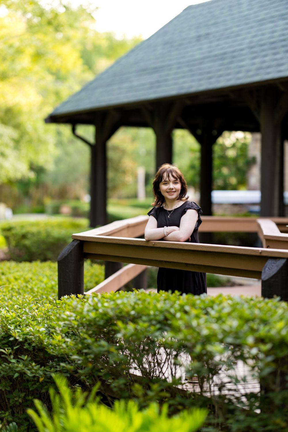 Garden pavilion with stone columns surrounded by manicured hedges. Photos by Tampa Photographer DigitalMyst Photography