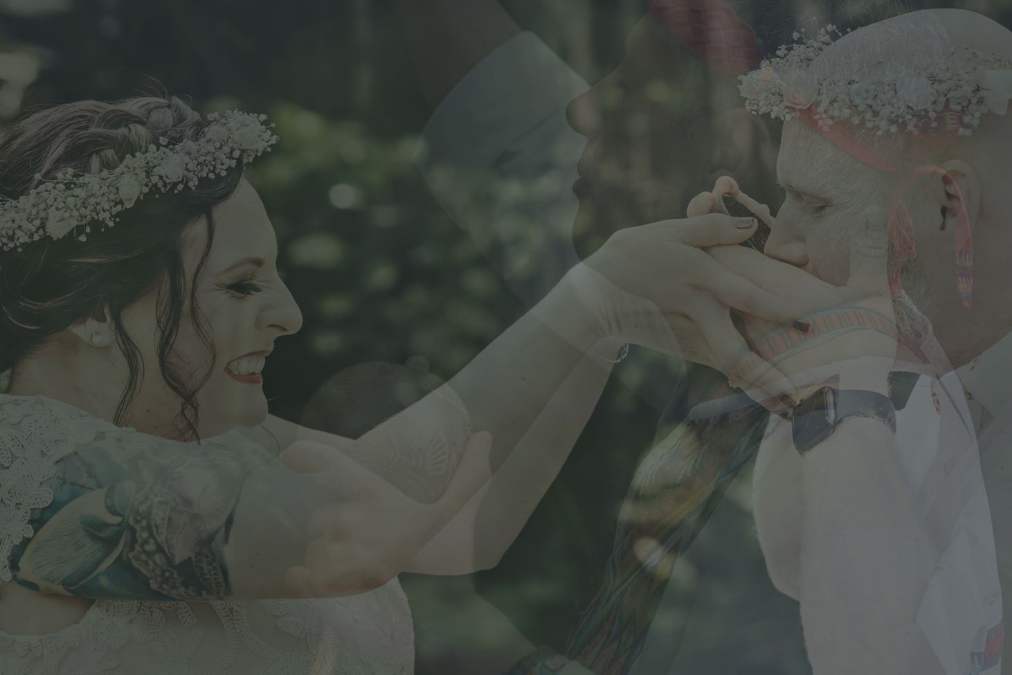 A tender wedding moment between a couple in an outdoor garden setting as they share a romantic gesture.
