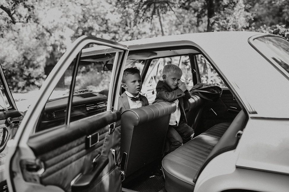 Classic vintage car interior shot in black and white at a wedding.
