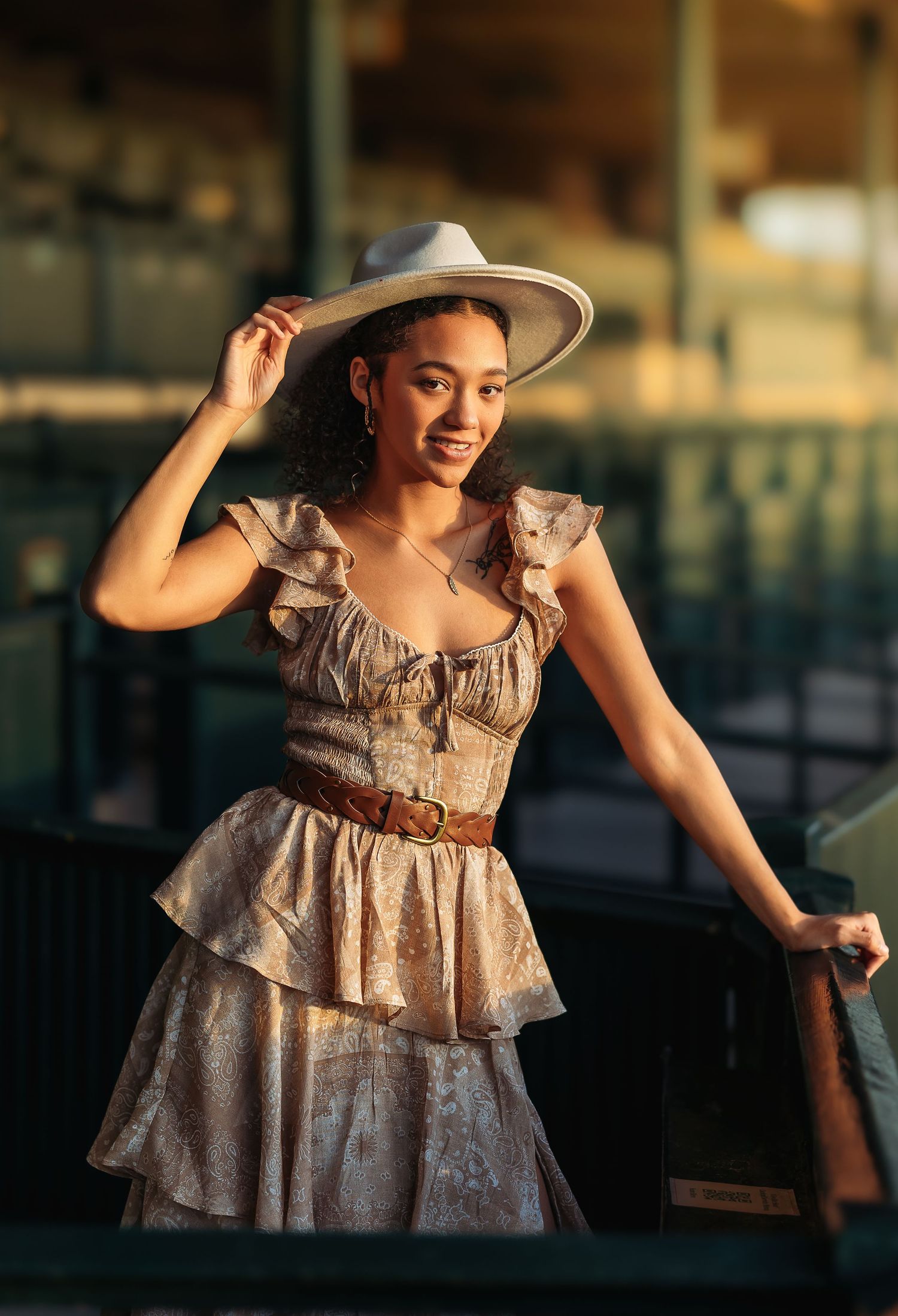 A child wearing a vintage-style ruffled dress twirls gracefully in warm evening light while dancing on an outdoor deck.