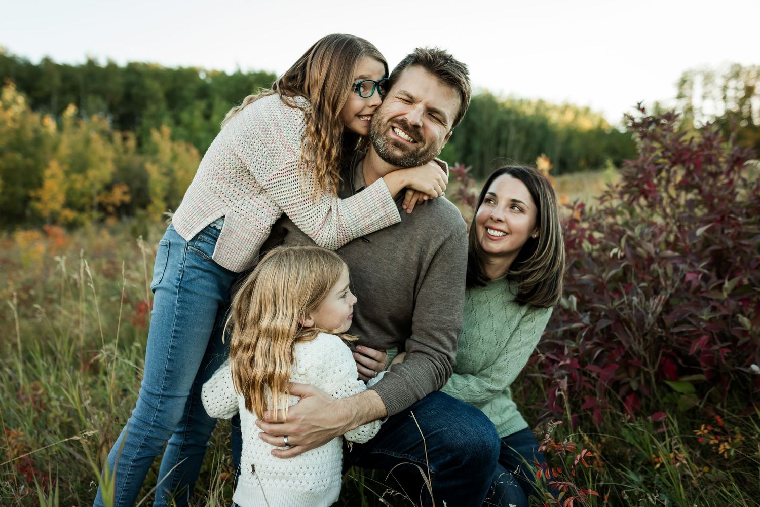 Fall family lifestyle photos at golden hour at Nose Hill Park in Calgary by Love & Sunshine Photography.