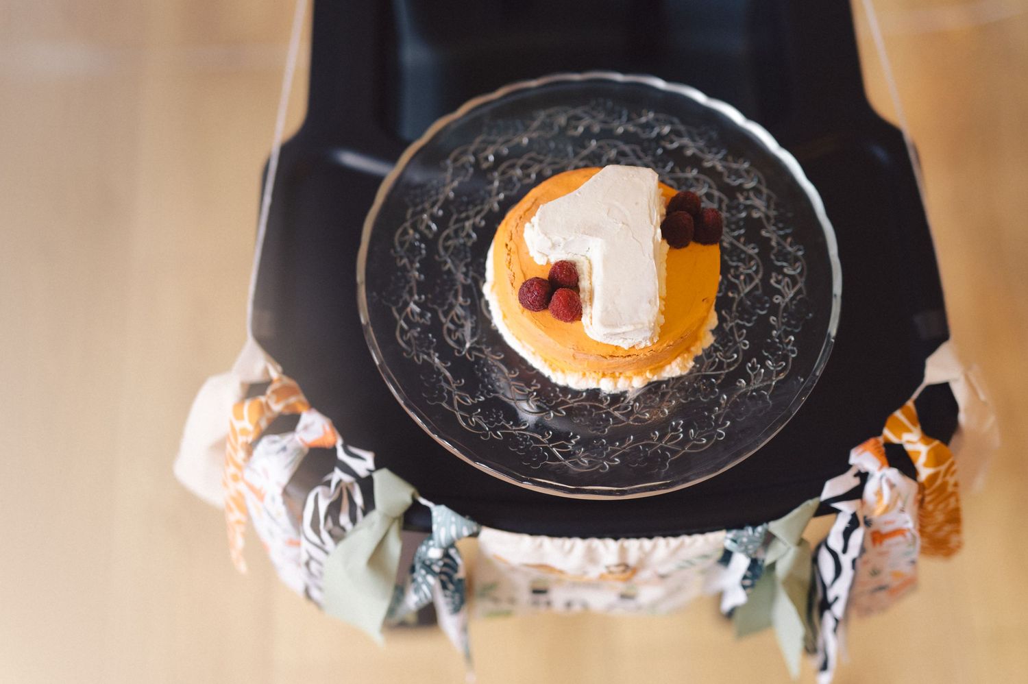 A poached egg sits in the center of a black plate on top of a decorative cloth napkin.
