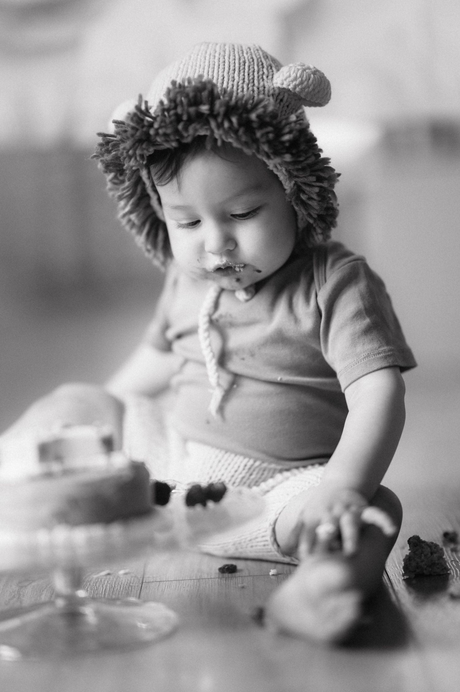 A series of black and white images showing small hands grasping snacks or treats in what appears to be a dining setting.