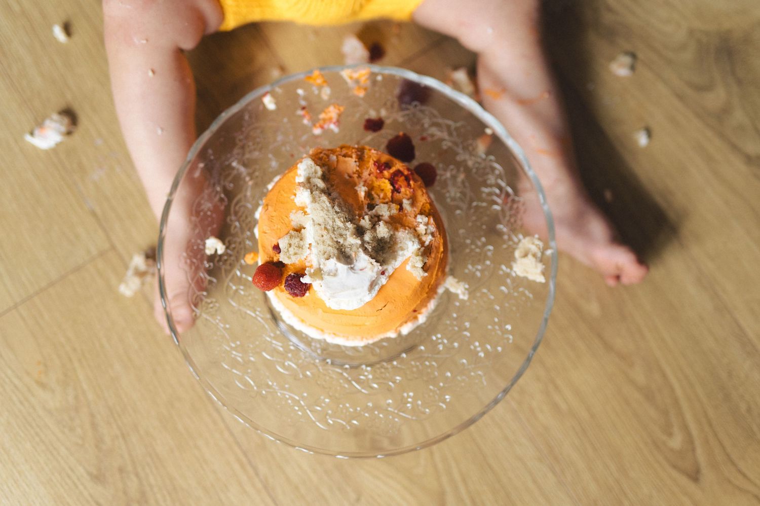 Step by step photos showing homemade cinnamon rolls being assembled and drizzled with icing on a wooden surface.