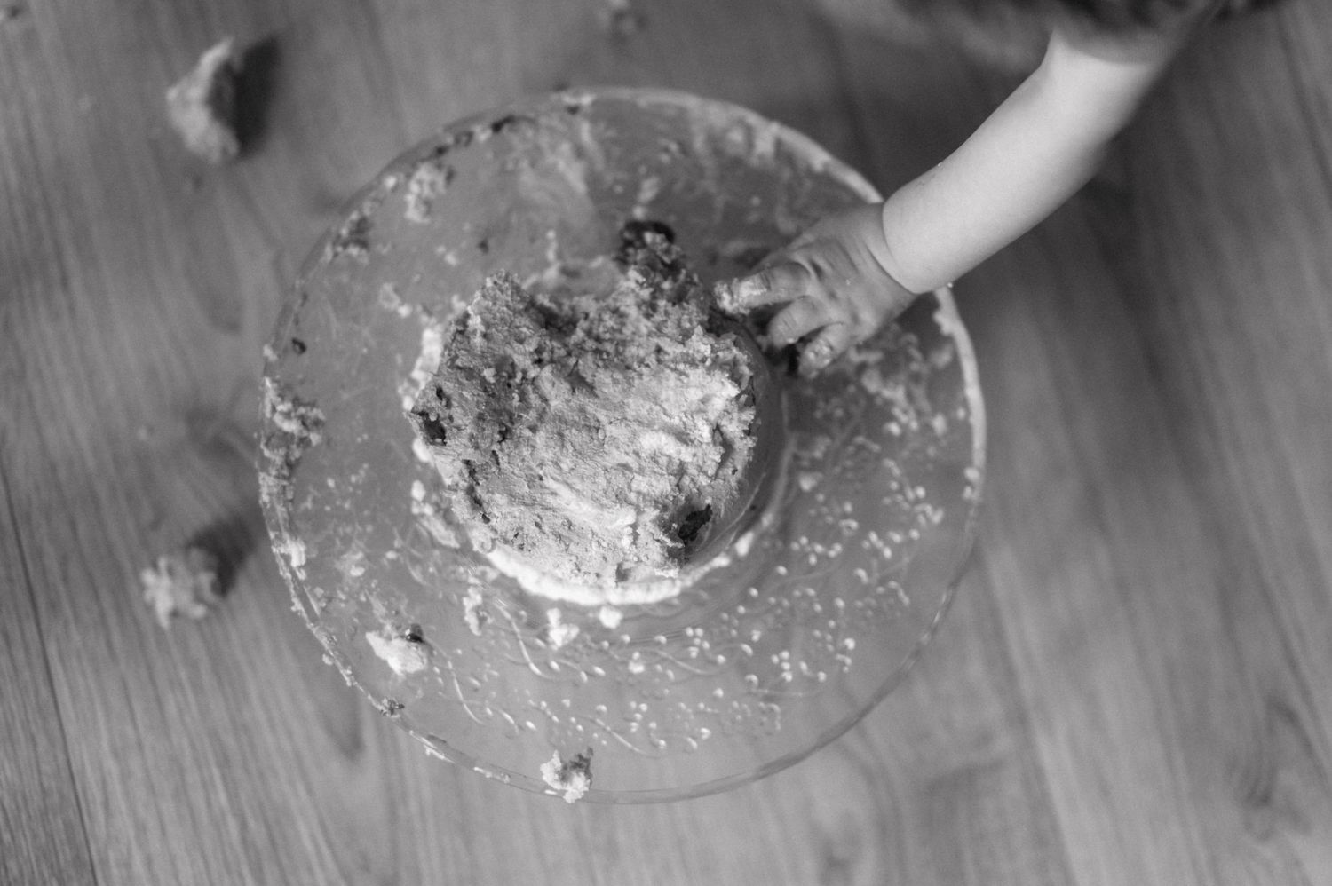 Round bread dough is kneaded and shaped on a wooden cutting board with flour.