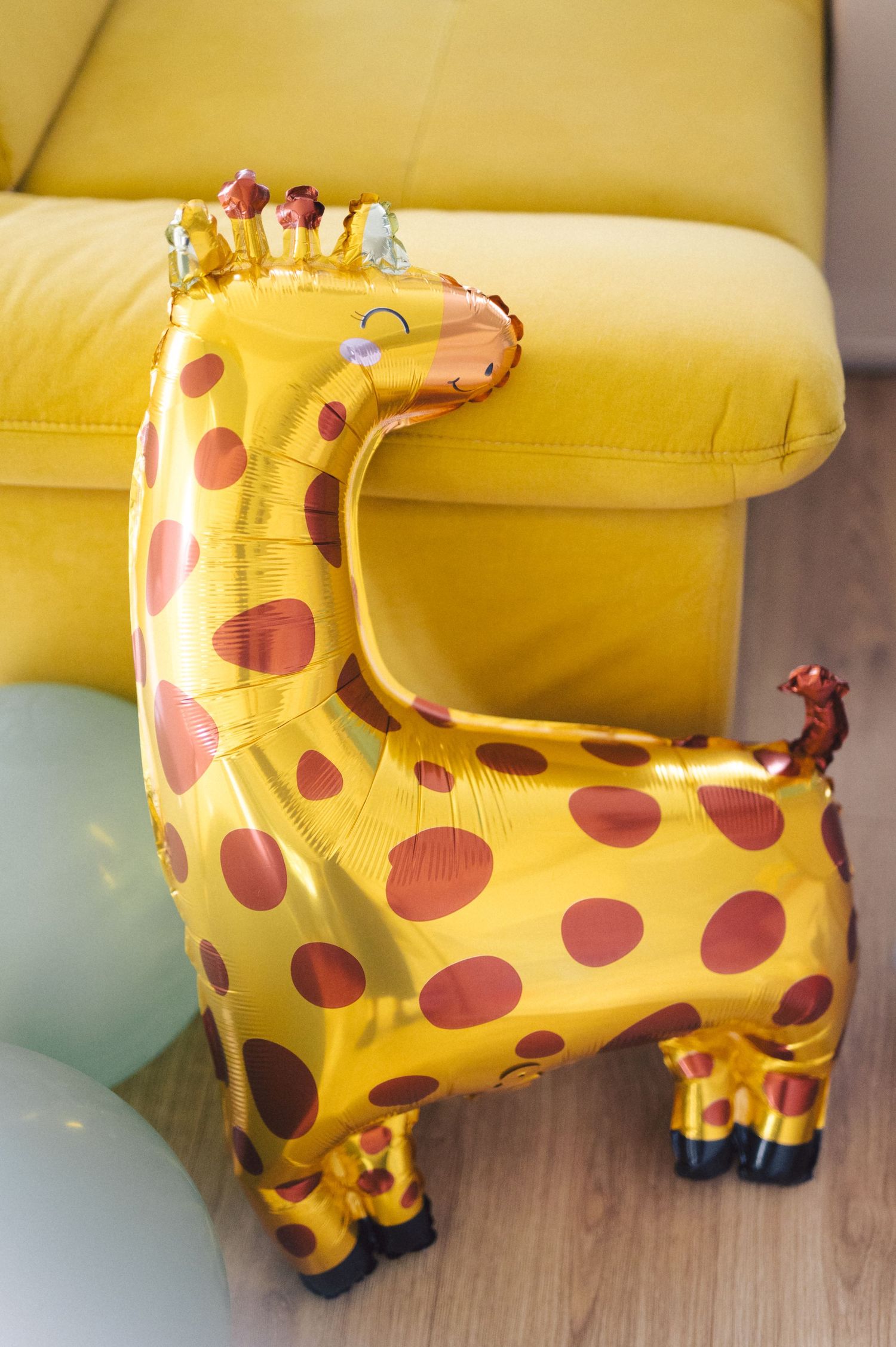 A sequence of images showing a yellow and brown giraffe plush toy inflating or being filled with air.