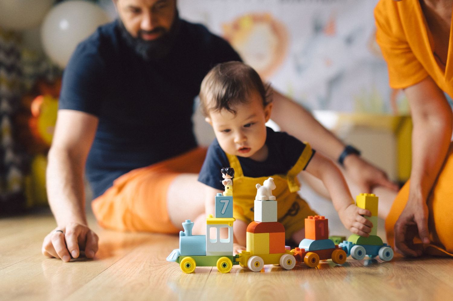 A colorful montage of children playing with wooden toy trains and blocks, showing various moments of creative play time.