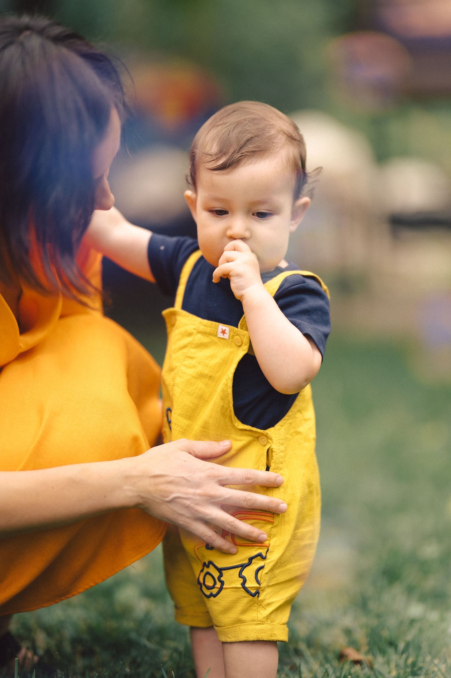 Series of candid outdoor shots showing playful interaction between someone in yellow and someone wearing navy clothing.