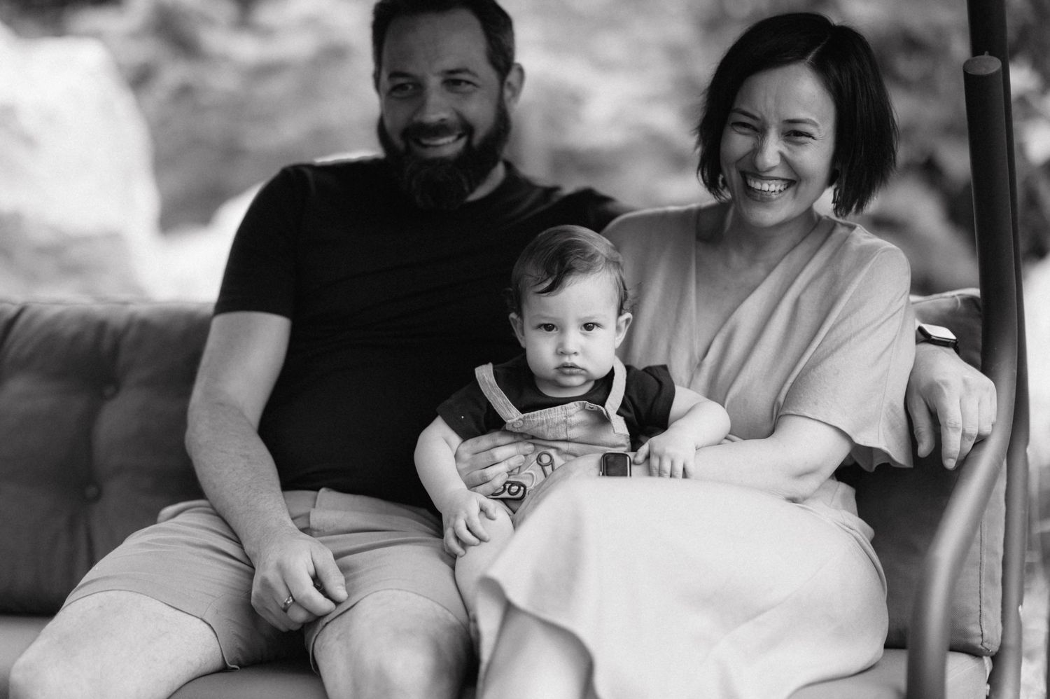 Black and white montage shows loving family moments with parents and children embracing and smiling together.