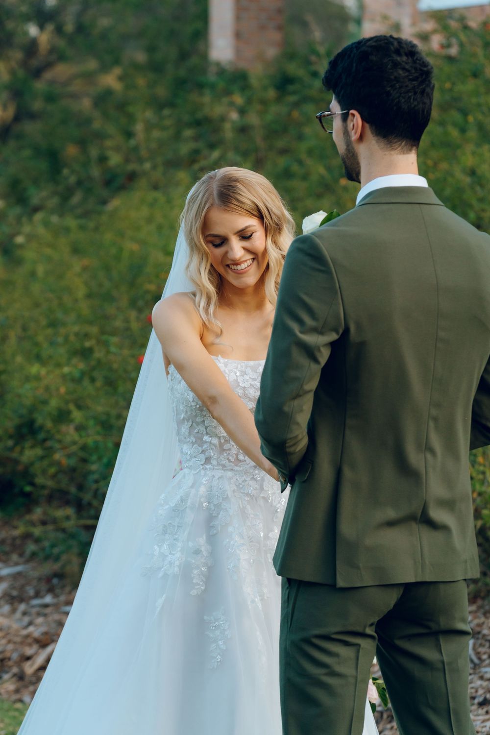 A sweet moment between newlyweds during their garden wedding ceremony.
