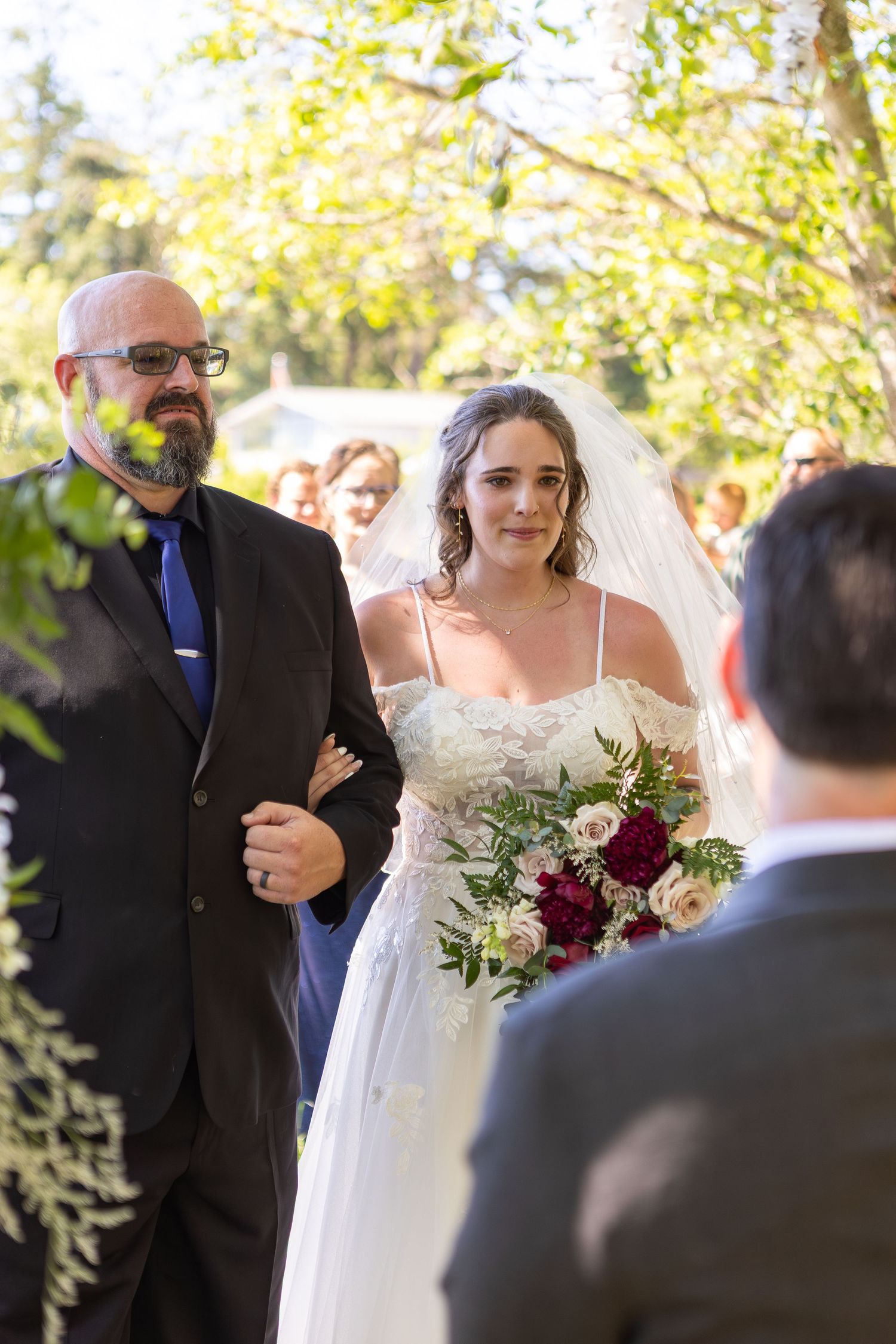 Outdoor wedding ceremony under autumn trees with emotional exchange.