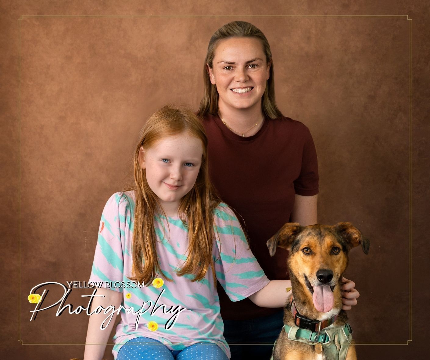 Pet photography session showing person in tie dye shirt posing with brown and white mixed breed dog.