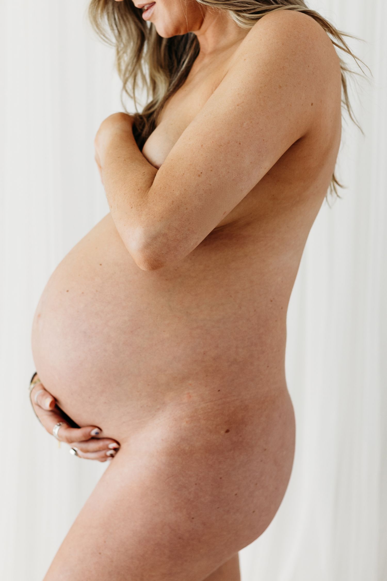 Maternity photography in Nottingham studio, natural and elegant portraits celebrating pregnancy in soft neutral tones.