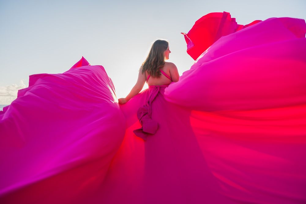Maui flying dress photographer photo against beautiful Maui sunset beach cliff  by ohwowfotos.