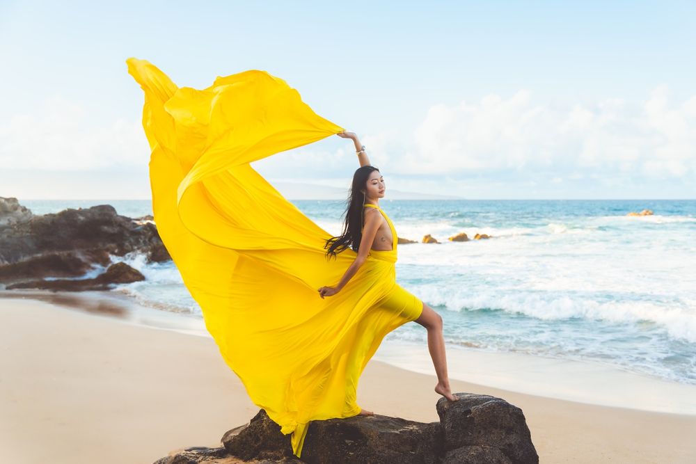 Maui flying dress photographer photo against beautiful Maui sunset beach cliff  by ohwowfotos.