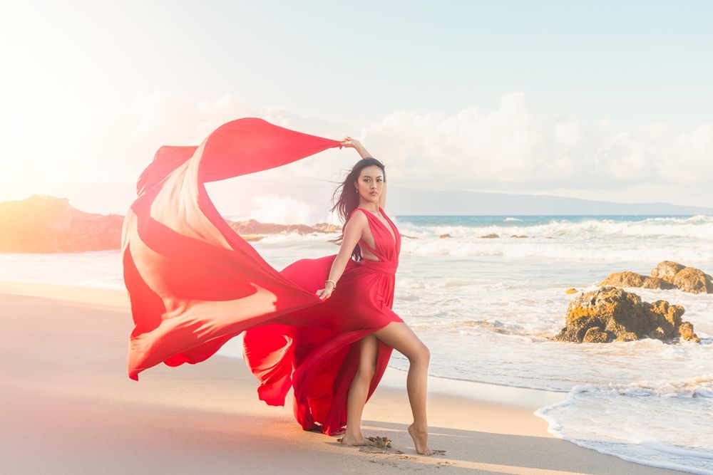 Maui flying dress photographer photo against beautiful Maui sunset beach cliff by ohwowfotos.