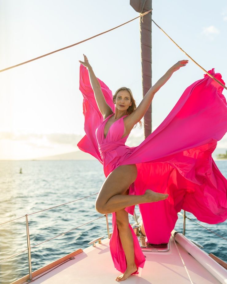 Maui flying dress photographer photo against beautiful Maui sunset Saltydogsailingmaui sailing boat  by ohwowfotos.